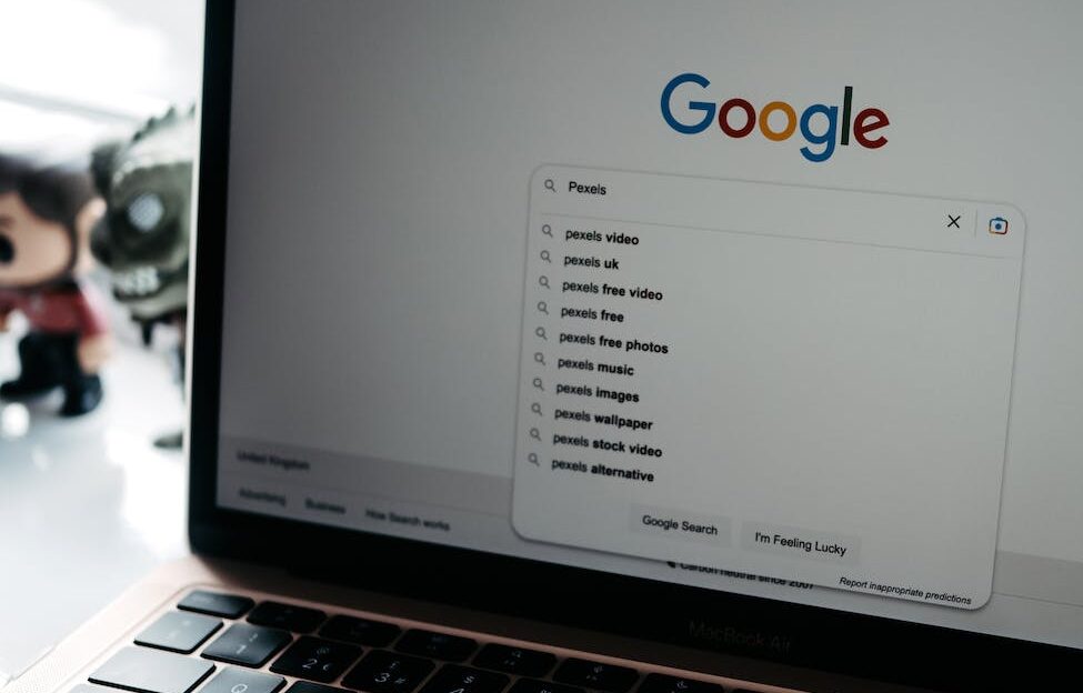photo of a laptop screen with google main page on it