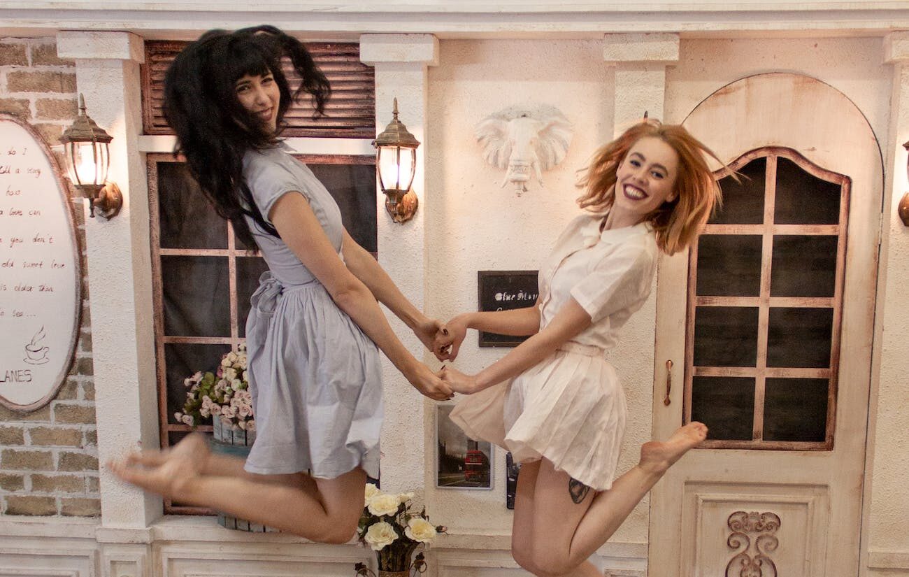 photo of two women jumping