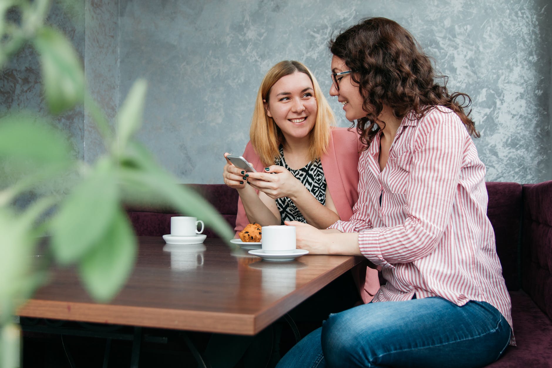 two women dining on brown wooden table