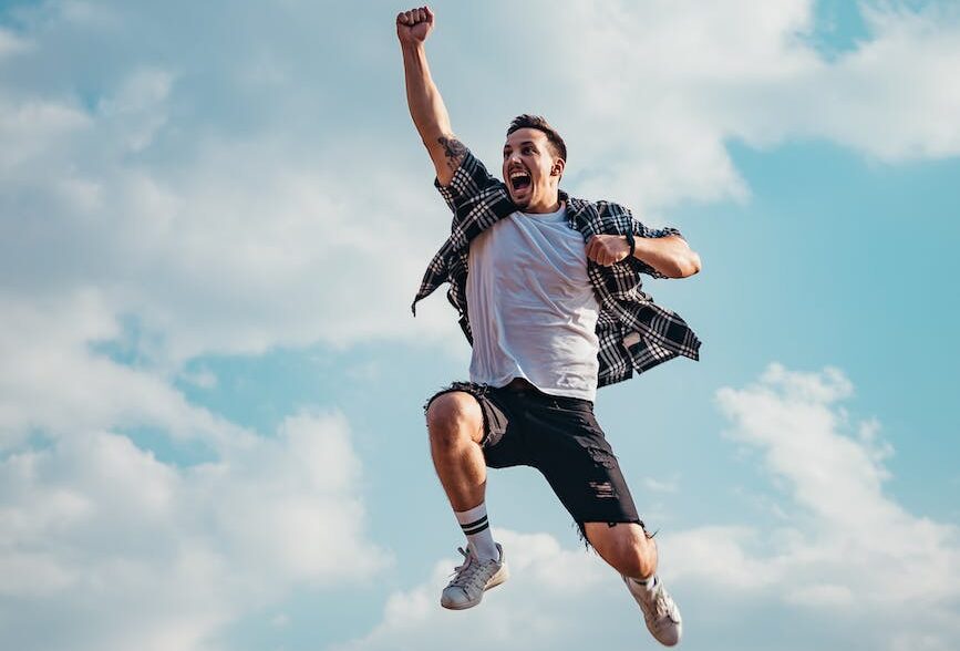 man jumping from a rock