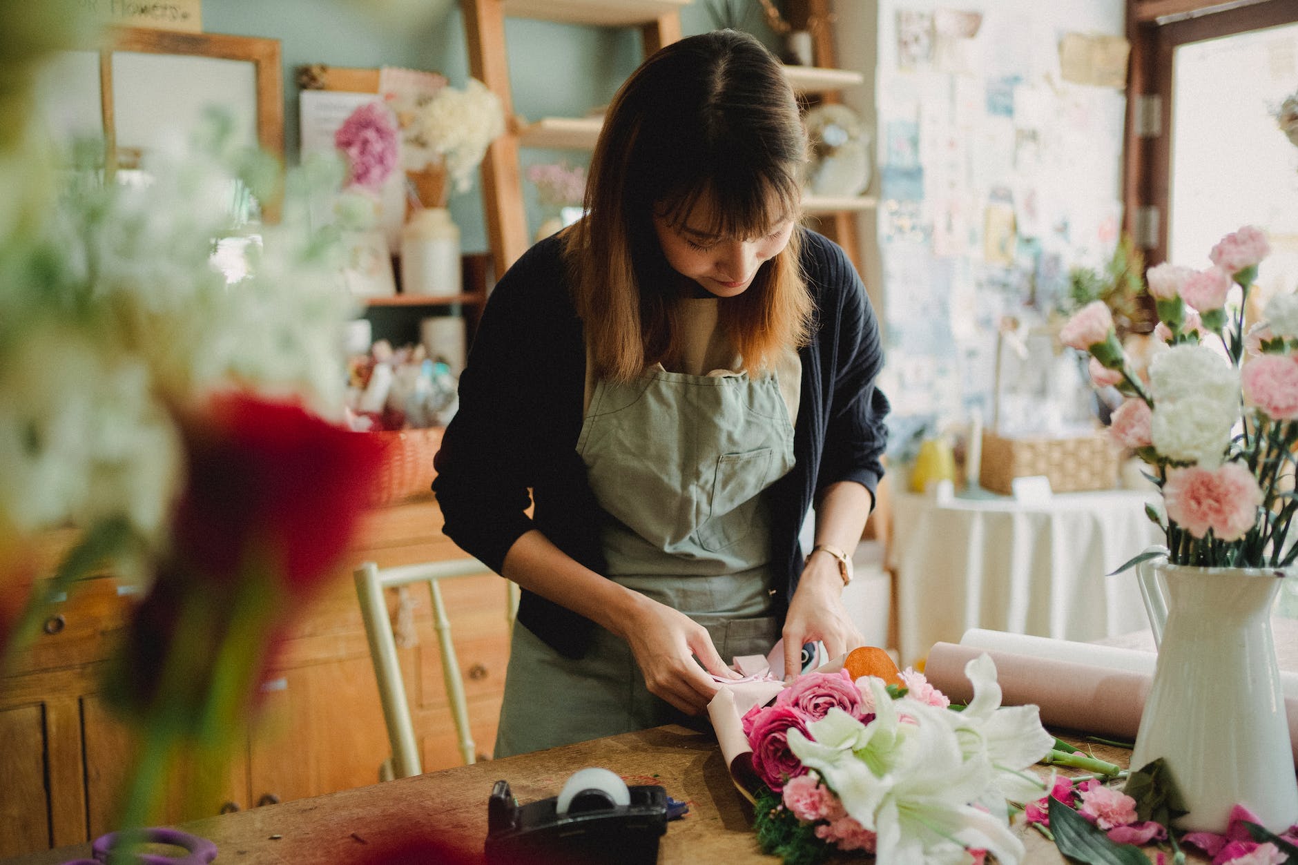 woman making floral bouquet in shop