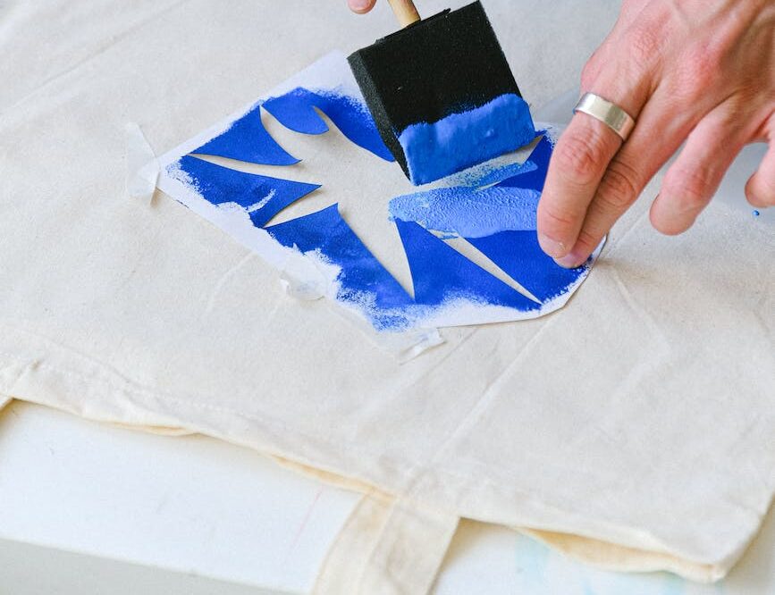 crop man transferring sketch on bag