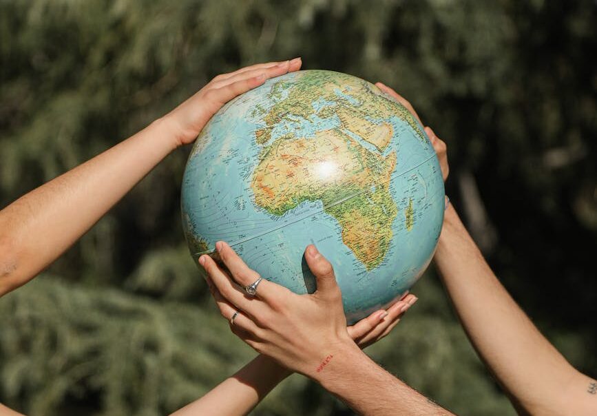 people holding a globe