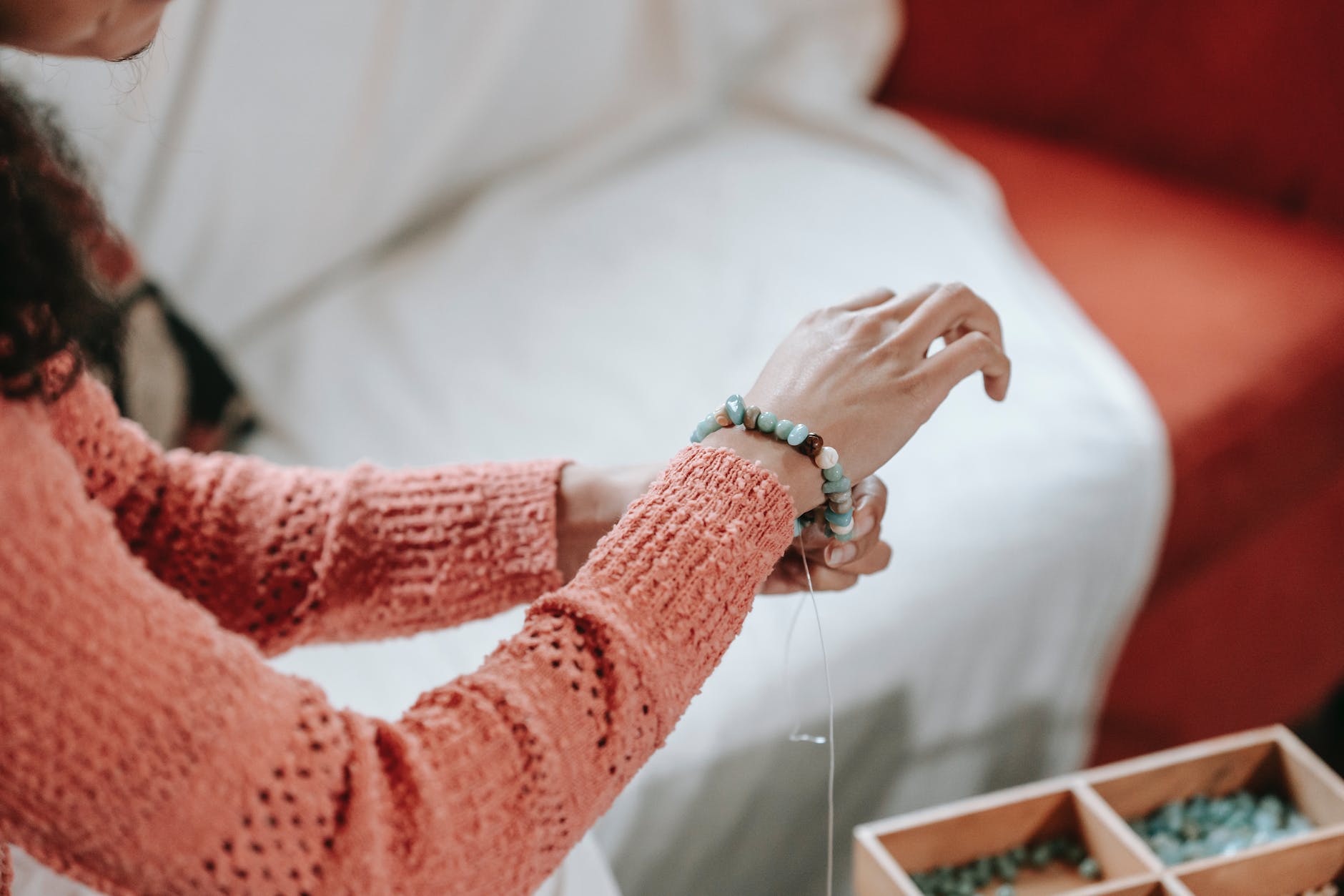 woman pitting on handmade bracelet made of stones