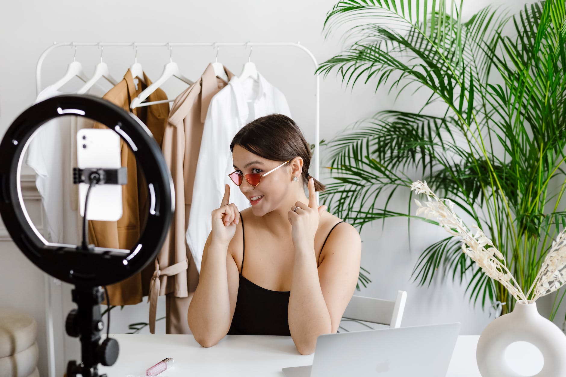 a woman showing her sunglasses to a video recording